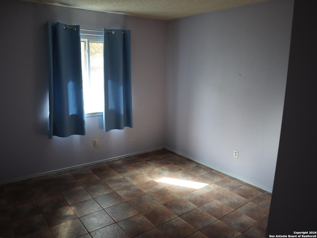 empty room featuring a textured ceiling