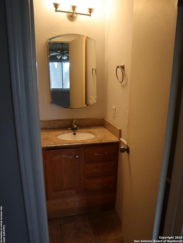 bathroom featuring tile patterned floors, ceiling fan, and vanity