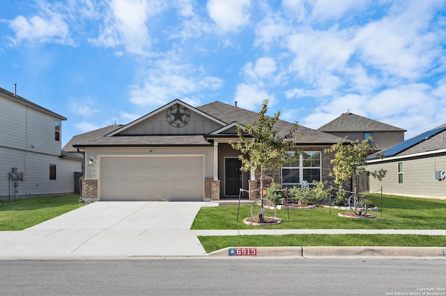 view of front of property with a front yard and a garage