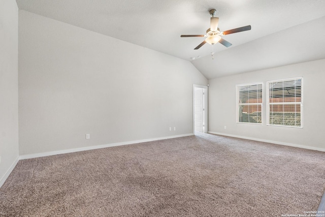 empty room with carpet, vaulted ceiling, and ceiling fan