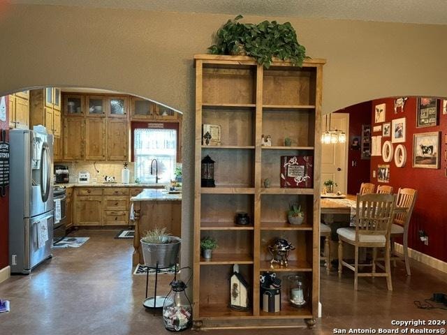 kitchen with stainless steel fridge, stove, and sink