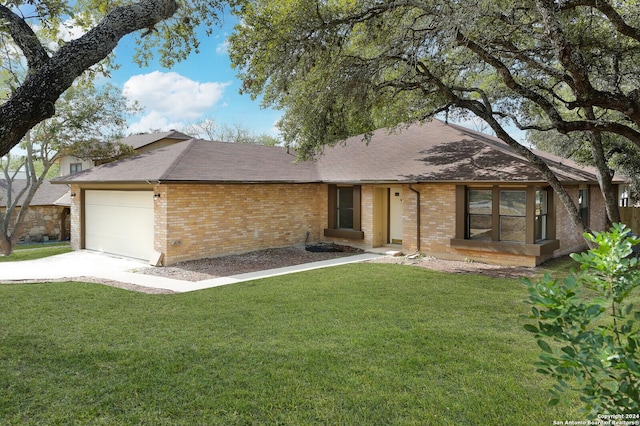 single story home featuring a front yard and a garage