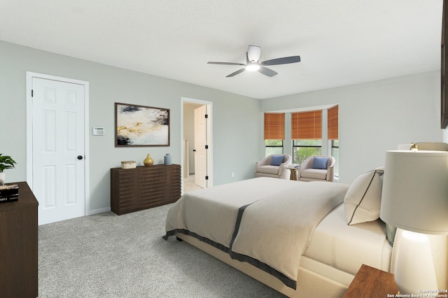 bedroom with ceiling fan and light colored carpet