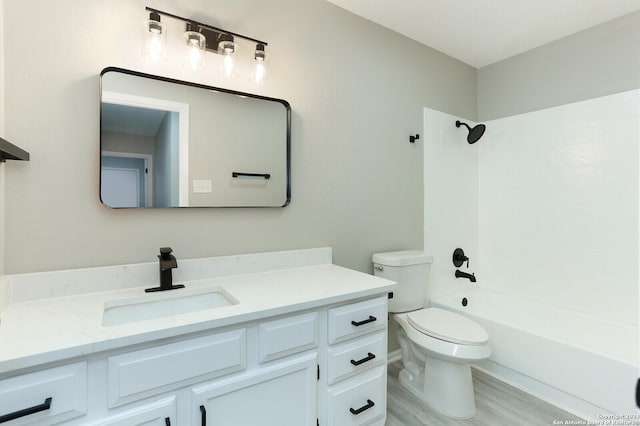 full bathroom featuring shower / bathing tub combination, vanity, toilet, and hardwood / wood-style flooring