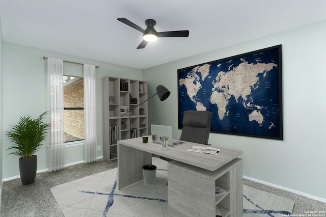 home office featuring ceiling fan and light carpet