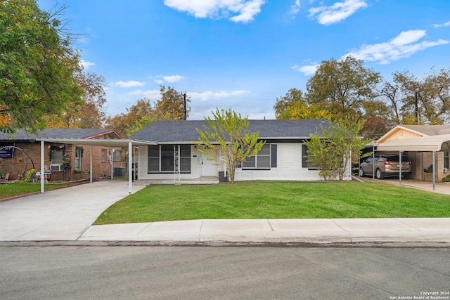 ranch-style home featuring a front yard and a carport