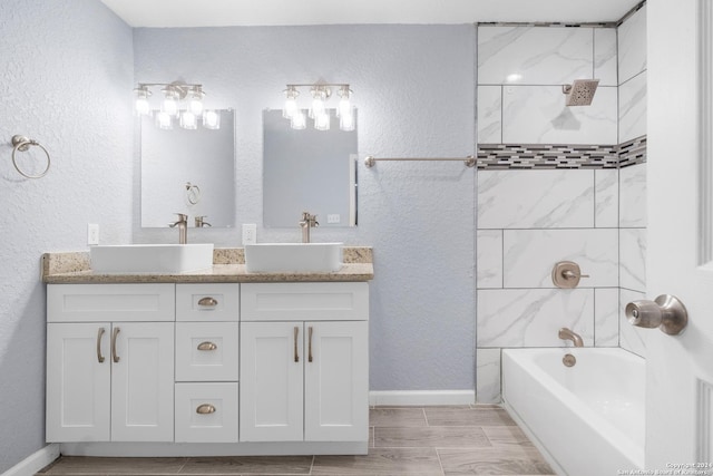 bathroom with vanity and tiled shower / bath combo