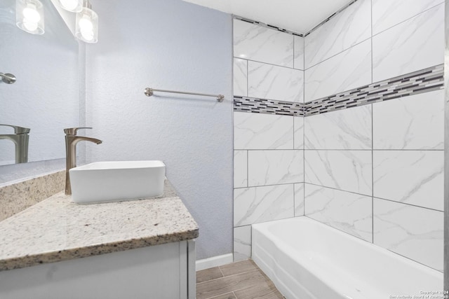 bathroom with vanity and tiled shower / bath