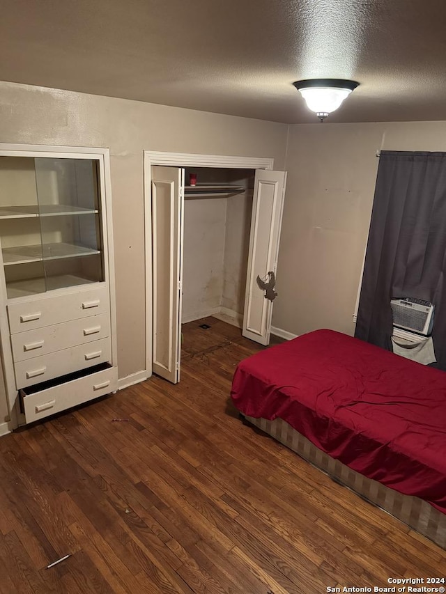 unfurnished bedroom with dark hardwood / wood-style floors and a textured ceiling