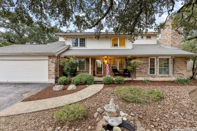 view of front of house with a porch and a garage