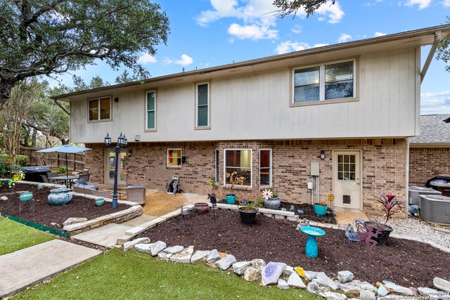 back of house with a patio area and central AC