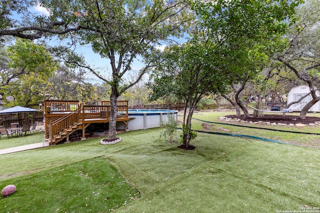 view of yard with a swimming pool side deck