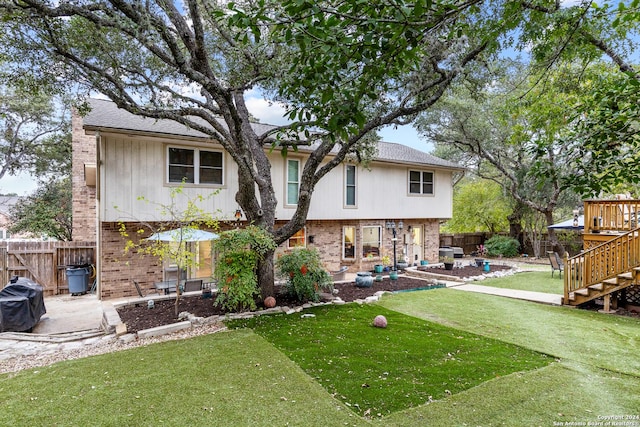 back of property featuring a patio area and a yard