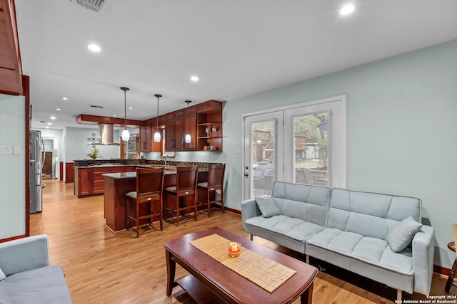 living room with french doors and light hardwood / wood-style flooring