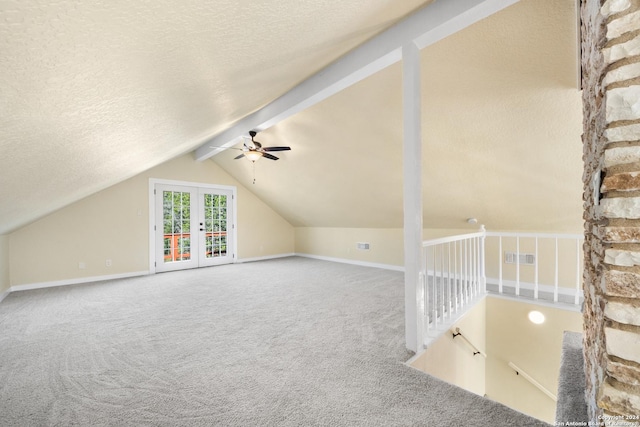 additional living space with carpet flooring, french doors, vaulted ceiling with beams, and ceiling fan