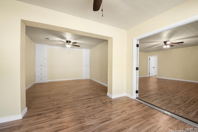 spare room featuring a textured ceiling and hardwood / wood-style flooring