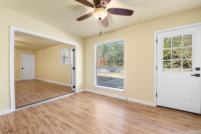 interior space featuring light wood-type flooring, a wealth of natural light, and ceiling fan