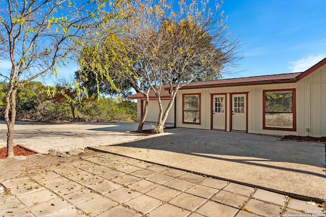 back of house featuring a garage