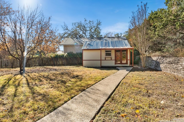 view of front of house featuring an outbuilding and a front lawn