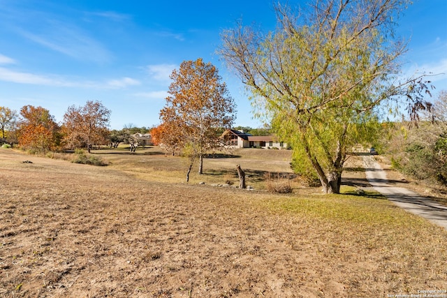 view of home's community with a yard and a rural view