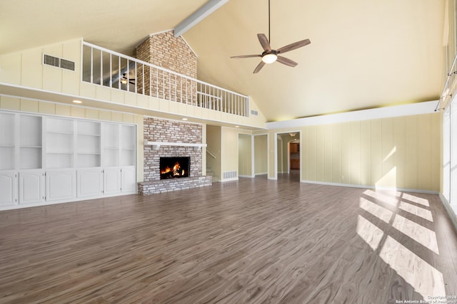 unfurnished living room featuring ceiling fan, a brick fireplace, beamed ceiling, high vaulted ceiling, and hardwood / wood-style flooring