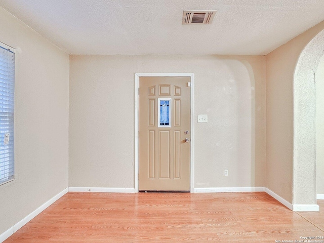 entryway featuring hardwood / wood-style floors and a textured ceiling