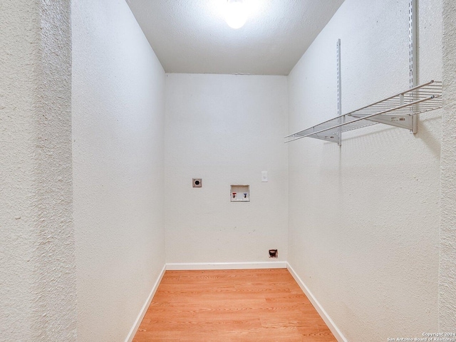 clothes washing area with hookup for an electric dryer, wood-type flooring, and hookup for a washing machine