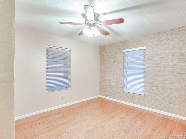 unfurnished room with ceiling fan and light hardwood / wood-style flooring