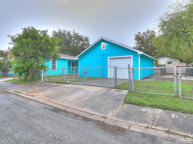 view of front of house with a garage and a front lawn