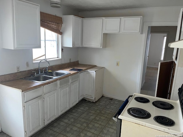 kitchen with white range with electric cooktop, white cabinetry, sink, and crown molding