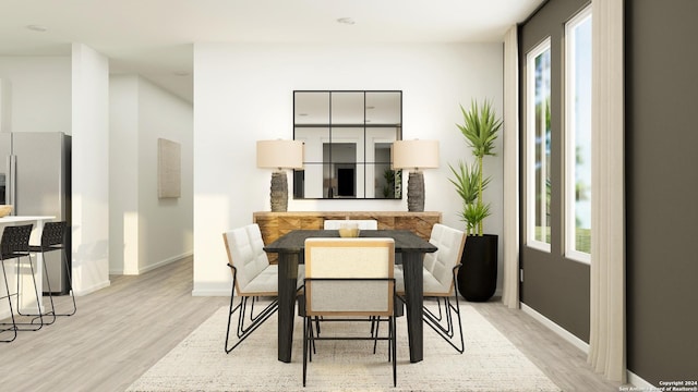 dining space featuring plenty of natural light and light hardwood / wood-style flooring