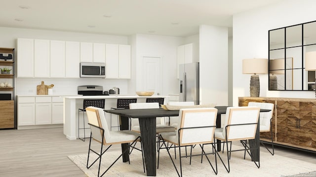 kitchen with backsplash, white cabinets, stainless steel appliances, and light hardwood / wood-style floors