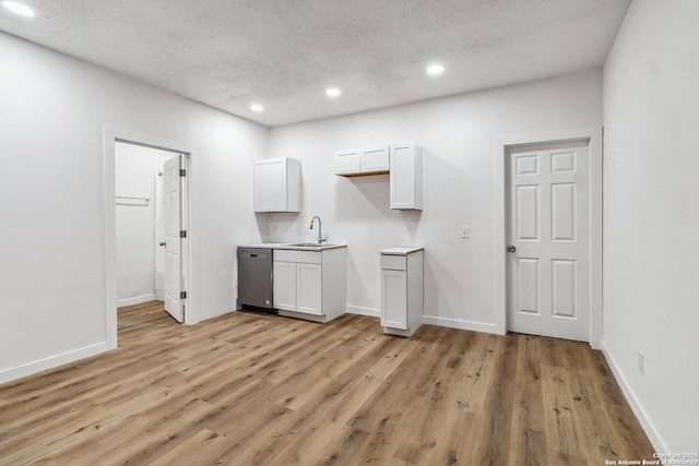 1206 W Hein Rd, San Antonio, TX 78220 - interior space featuring white cabinets, stainless steel dishwasher, recessed lighting, and a textured ceiling