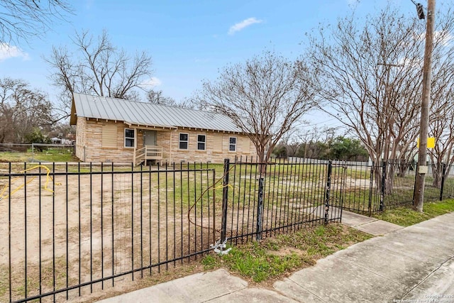 1206 W Hein Rd, San Antonio, TX 78220 - exterior space with a gate, a fenced front yard, a yard, stone siding, and metal roof