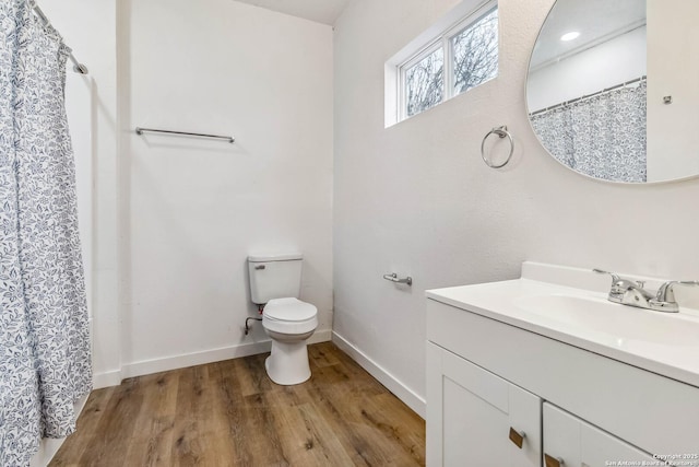 1206 W Hein Rd, San Antonio, TX 78220 - full bathroom featuring baseboards, wood finished floors, vanity, and toilet