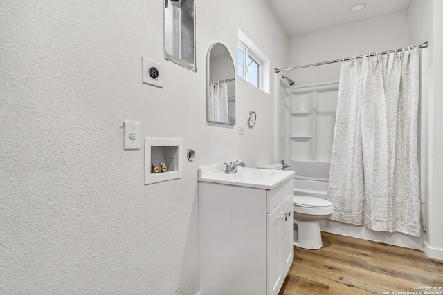 1206 W Hein Rd, San Antonio, TX 78220 - full bathroom featuring shower / bathtub combination with curtain, wood finished floors, a textured wall, toilet, and vanity