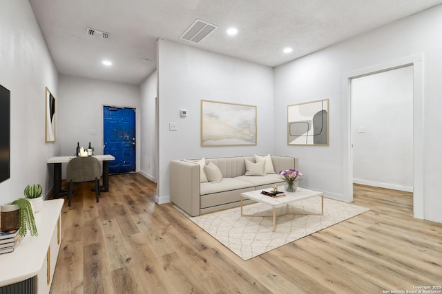 1206 W Hein Rd, San Antonio, TX 78220 - living room with baseboards, visible vents, recessed lighting, and light wood-style floors