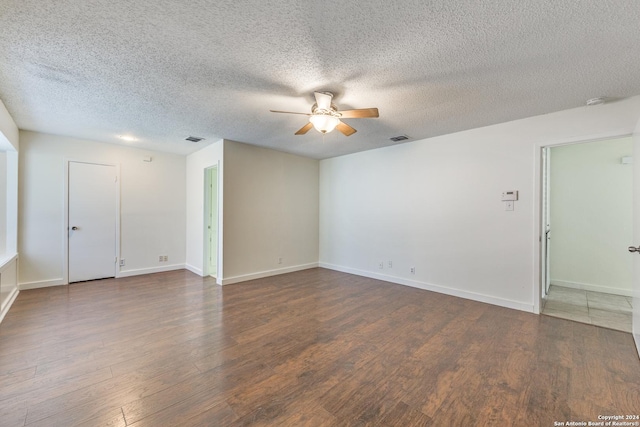 unfurnished room featuring a textured ceiling, ceiling fan, and dark hardwood / wood-style floors