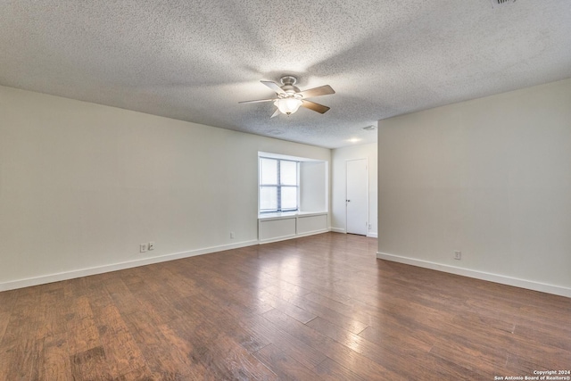 unfurnished room with ceiling fan, dark wood-type flooring, and a textured ceiling