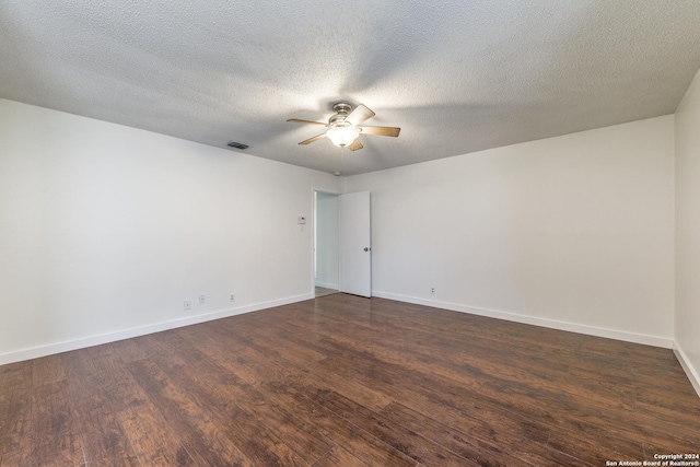 spare room with ceiling fan, dark hardwood / wood-style floors, and a textured ceiling