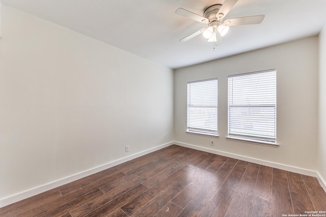 spare room featuring dark hardwood / wood-style flooring and ceiling fan