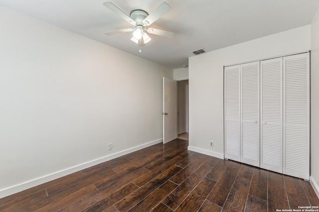 unfurnished bedroom featuring a closet, ceiling fan, and dark wood-type flooring