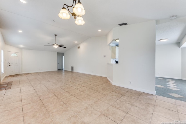 spare room featuring vaulted ceiling and ceiling fan with notable chandelier