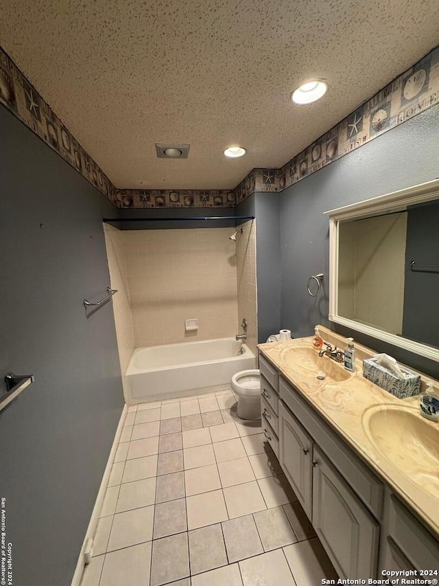 full bathroom featuring tile patterned floors, a textured ceiling, toilet, vanity, and bathtub / shower combination