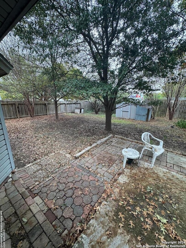 view of patio featuring a storage shed