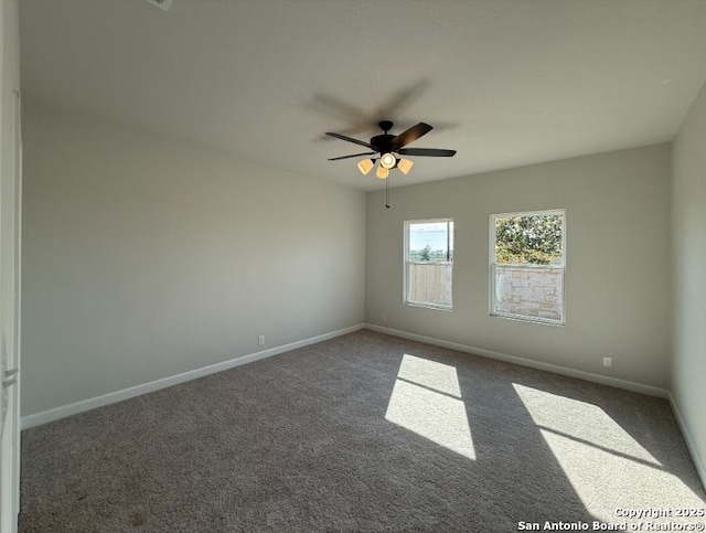 carpeted empty room featuring ceiling fan