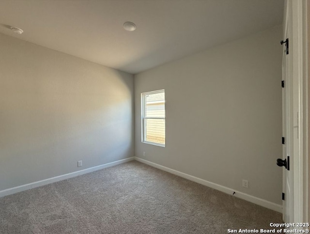 spare room featuring carpet