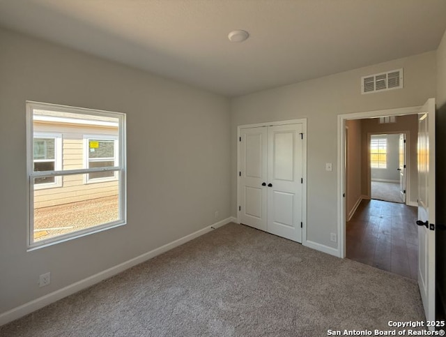 unfurnished bedroom with a closet and carpet floors