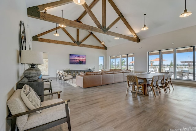 living room featuring beamed ceiling, hardwood / wood-style floors, and high vaulted ceiling