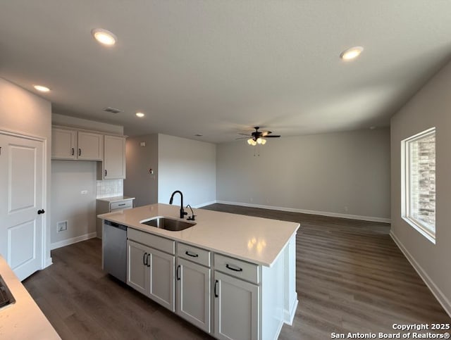 kitchen featuring white cabinetry, backsplash, a kitchen island with sink, stainless steel dishwasher, and sink